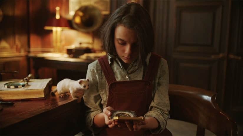 Pan and Lyra (Dafne Keen) examine the alethiometer. Still from His Dark Materials. BBC/HBO
