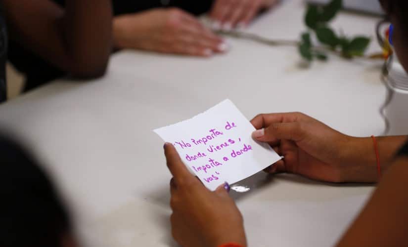 A migrant girl in US government custody holds a card that says, in Spanish, “It doesn’t matter where you come from, it matters where you are going,” during a lesson on reproductive health and self esteem in Lake Worth, Floriad in the US. AP