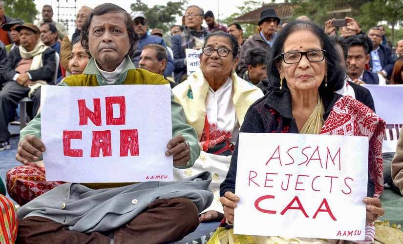 Senior citizens display placards during a protest against the Citizenship (Amendment) Act, at Latashil Playground in Guwahati. PTI