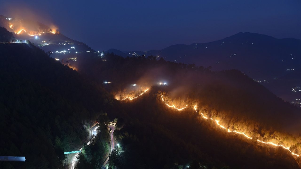 Wildfires burn in hills around New Tehri at Bourari in the Indian state of Uttarakhand in May 2018. Image: Prakash Singh/AFP via Getty