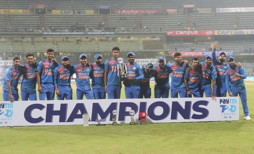 Indian team players pose with the trophy after winning the three-match T20I series against the West Indies 2-1. AP