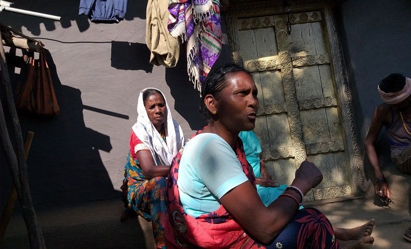 Bertila Tirkey (in blue blouse) says voters are angry against political parties over mob lynchings in Gumla’s Jurmu village. Also seen (in the back) Prakash Lakda’s widow, Jermina. Firstpost/Natasha Trivedi