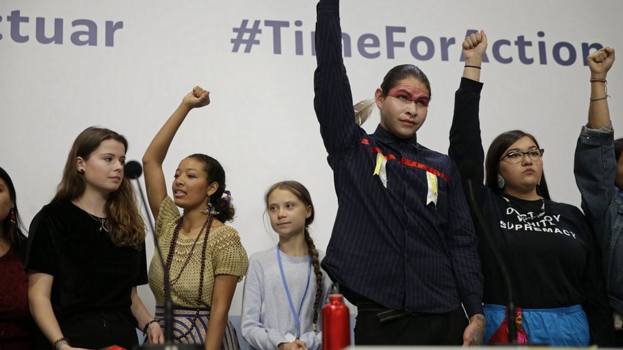 Greta Thunberg stands along with other climate activists on stage. Image credit: AP