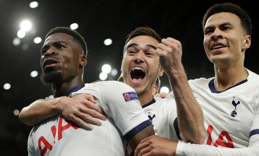 Tottenham’s Serge Aurier, left, celebrates his goal with teammates Harry Winks, center, and Dele Ali Champions League match against Olympiakos. AP