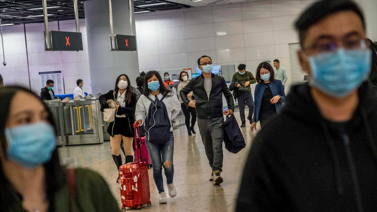 Travelers wear face masks at the West Kowloon train station in Hong Kong on Wednesday, Jan. 22, 2020. The mysterious new pneumonia-like coronavirus has turned the Lunar New Year holiday in China - the world’s largest annual migration of people - into an epidemiologist/s nightmare. (Lam Yik Fei/The New York Times)