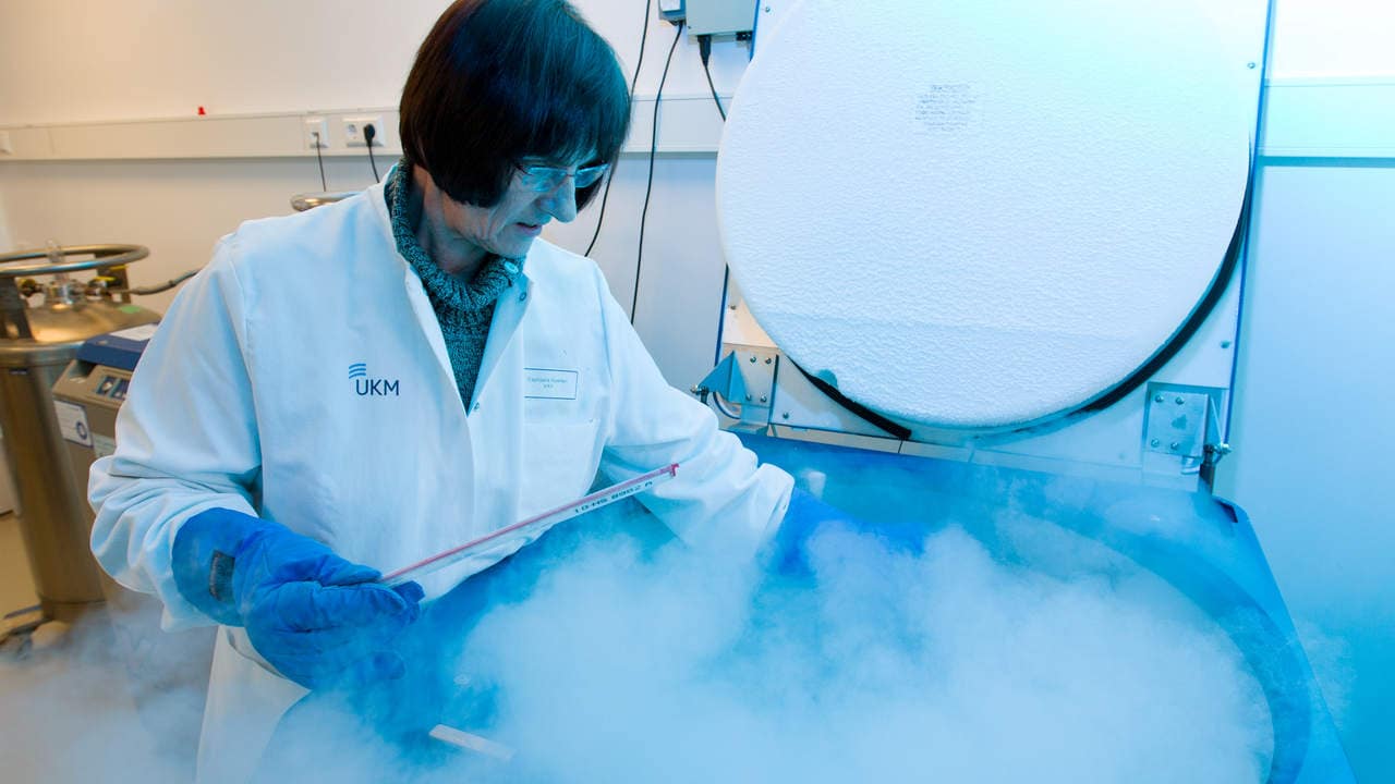 Medical-laboratory assistant Raphaele Kuerten stores sperm samples in a cryopreservation container at minus 170 degrees centigrade at the Centre for Reproductive Medicine in Muenster, Germany, 06 February 2013. Children by sperm donors have the right to know the name of their biological father. This was decided in a groundbreaking ruling by the Higher Regional Court in Hamm on 06 February 2013. Photo: FRISO GENTSCH | usage worldwide   (Photo by Friso Gentsch/picture alliance via Getty Images)