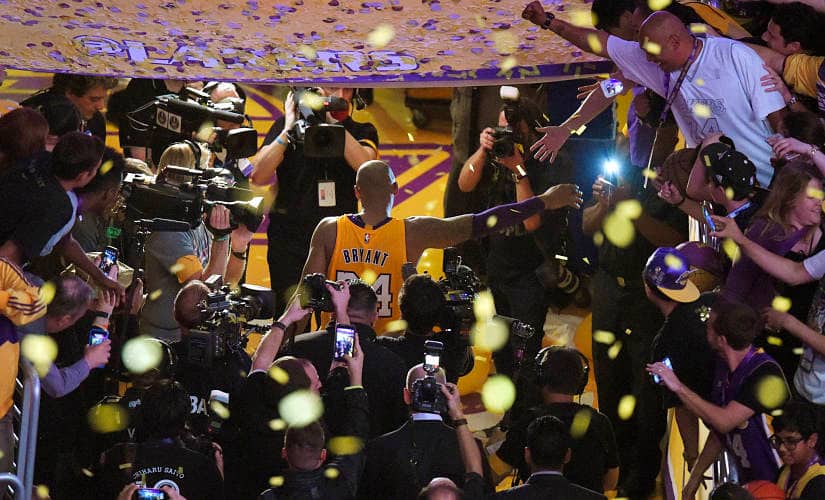 Los Angeles Lakers’ Kobe Bryant walks off the court after finishing his last NBA basketball game before retirement. AP Photo