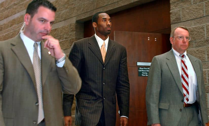 File image from 24 March, 2004 that shows Los Angeles Lakers&rsquo; Kobe Bryant (centre) walking out from proceedings in his sexual assault case in Eagle, Colorado. AP Photo
