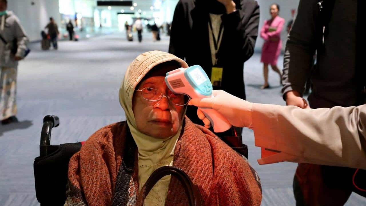 A women gets her temperature checked at the airport because of the spread of coronavirus. Image credit: AP