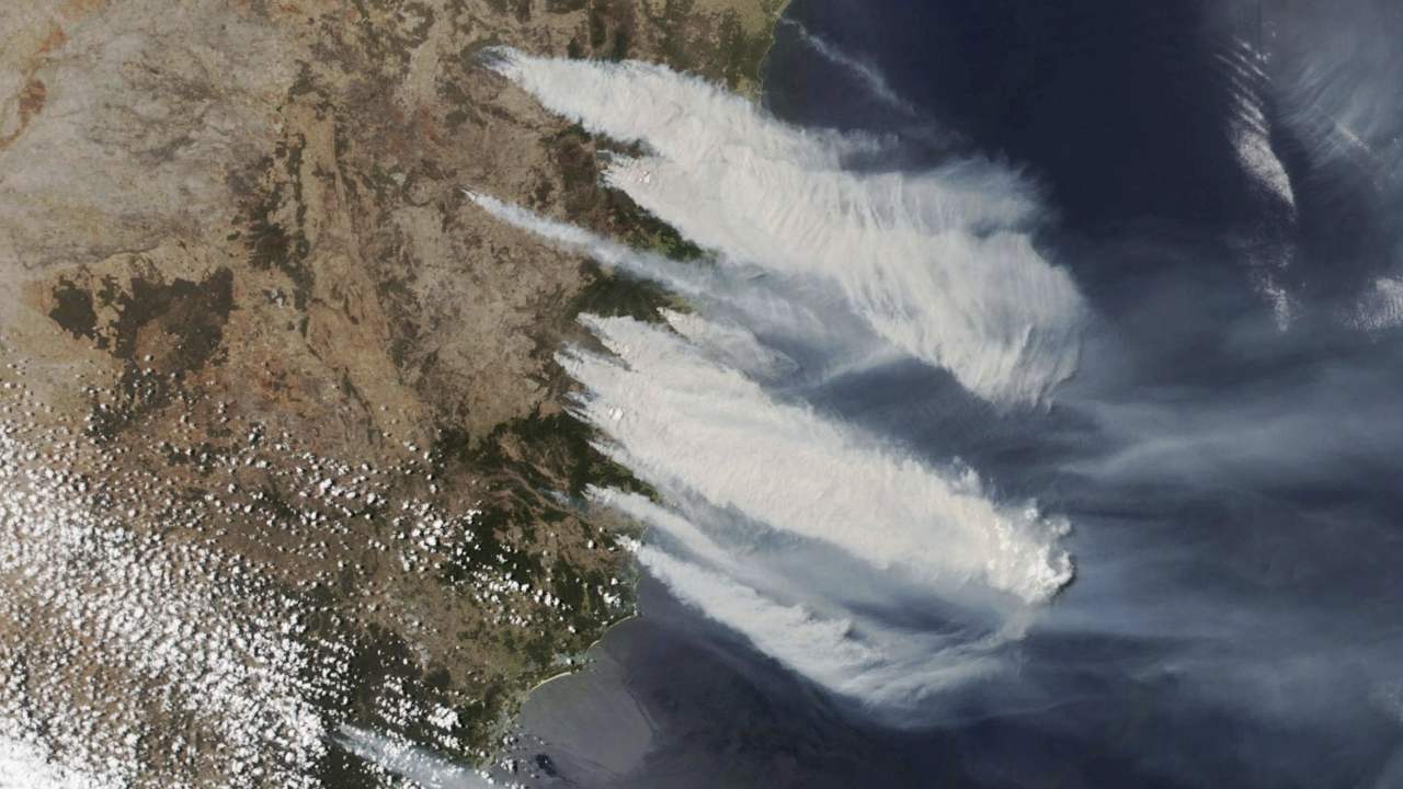 satellite photo taken by NASA shows hot, dry and windy weather conditions as bushfires burn in the eastern part of the New South Wales state of Australia.  Image credit: AP