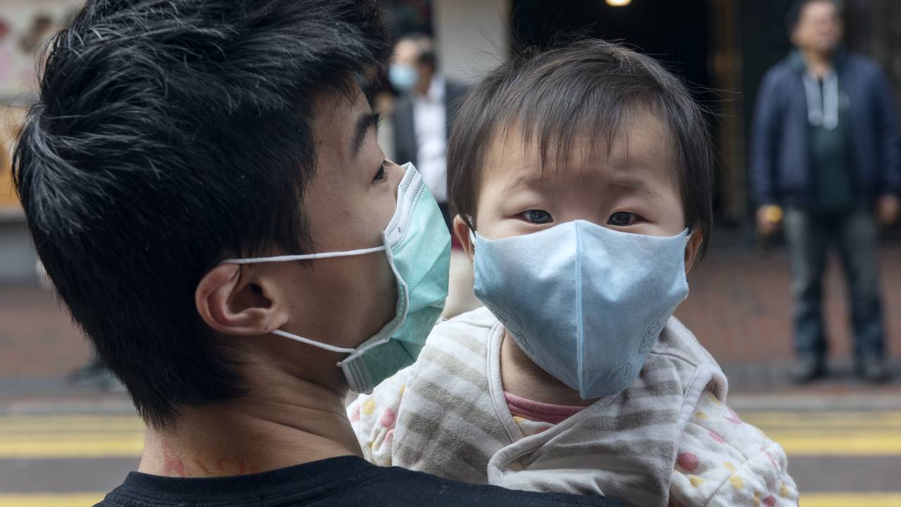 Father and his son wear face mask to prevent a coronavirus infection in Hong Kong, 3 Feb 2020. image: Miguel Candela Poblacion/Getty