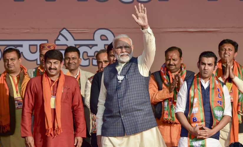 Prime Minister Narendra Modi and BJP leaders Manoj Tiwari and Gautam Gambhir during an electionr ally in East Delhi. PTI