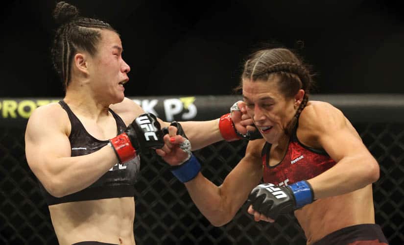 UFC women's strawweight champion Weili Zhang, left, of China punches former champion Joanna Jedrzejczyk of Poland during UFC 248. AP