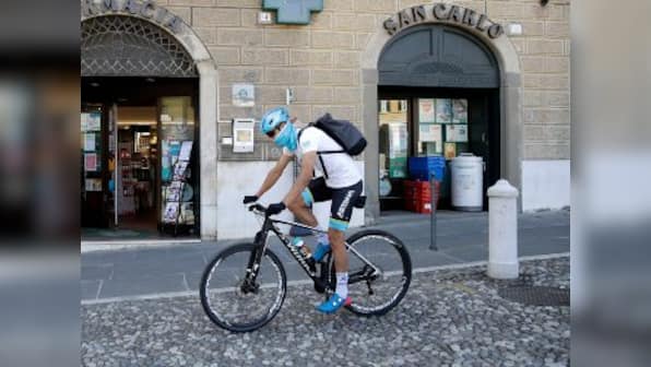 Coronavirus Outbreak: Professional cyclist Davide Martinelli using cycle to deliver medicie to elderly residents in Lodetto, Italy
