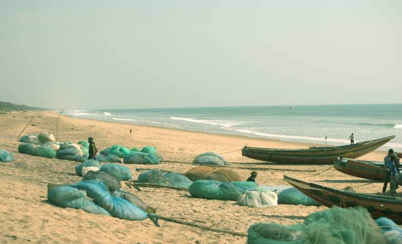 Fish nets and boats lay idle at Podampeta village near Rushikulya River mouth. Image/Basudev Mahapatra