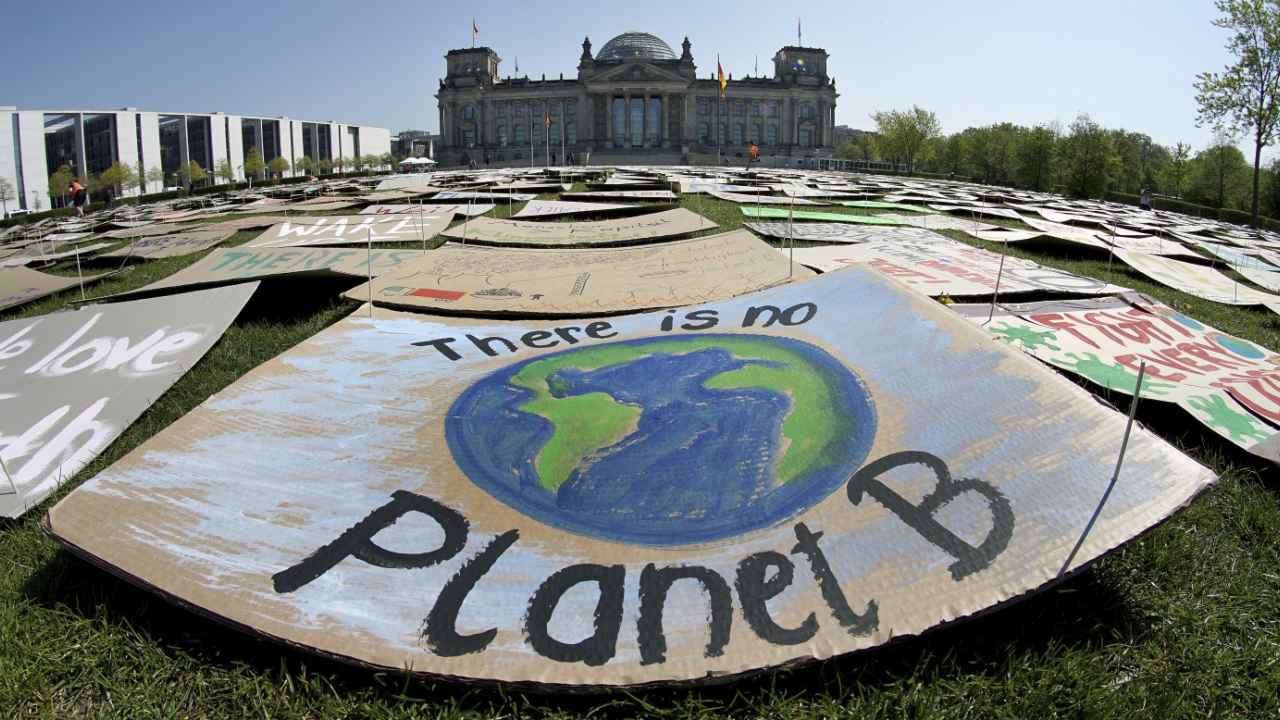 In this Friday, April 24, 2020 file photo, activists place thousands of protest placards in front of the Reichstag building, home of the german federal parliament, Bundestag, during a protest rally of the 'Fridays for Future' movement in Berlin, Germany. U.N. Secretary-General Antonio Guterres said Tuesday at a two-day international meeting on climate change, that the coronavirus pandemic has exposed how fragile societies are, but that if governments work together on common challenges, including global warming, it can be an opportunity to 'rebuild our world for the better.' Image