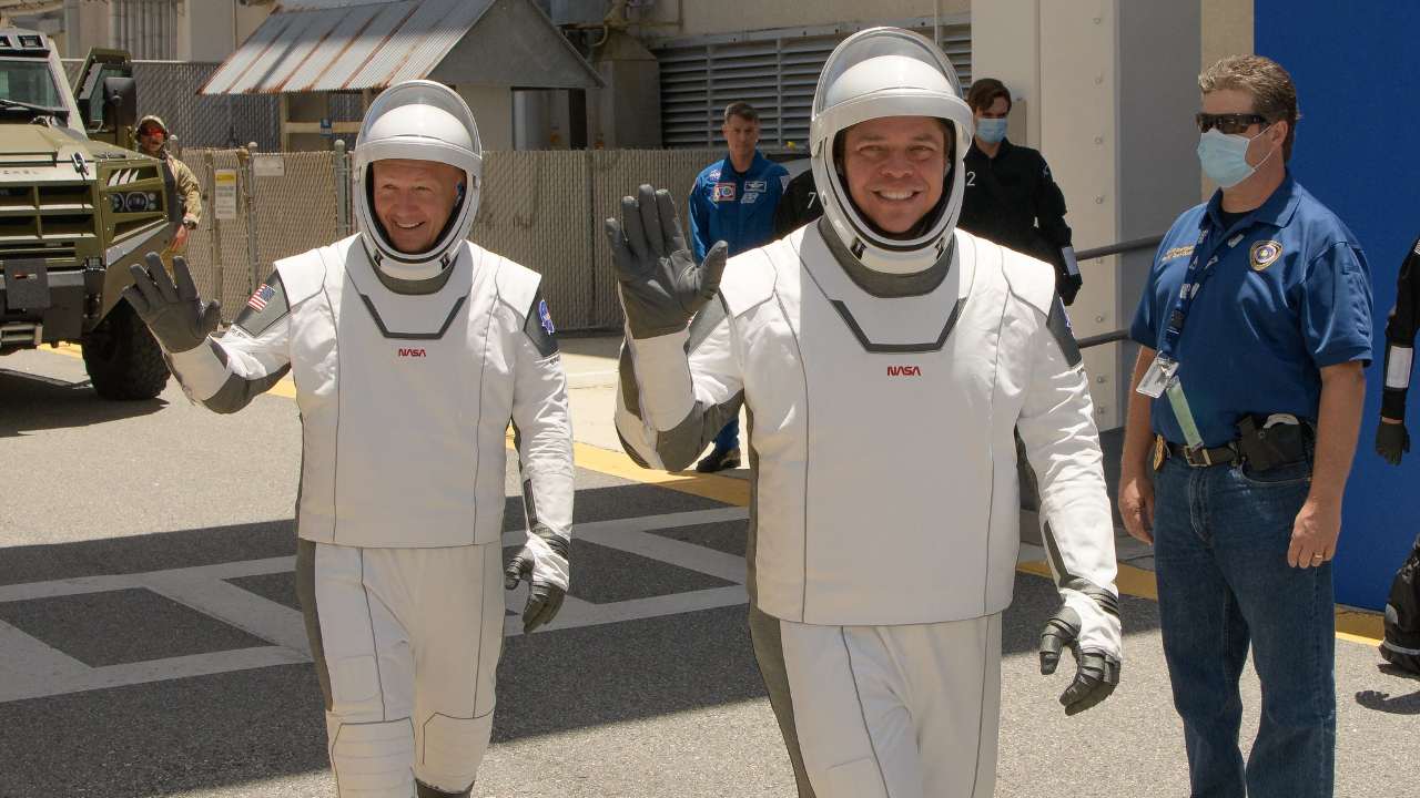 NASA astronauts Douglas Hurley, left, and Robert Behnken, wearing matchy-matchy SpaceX spacesuits, are seen as they depart the Neil A. Armstrong Operations and Checkout Building for Launch Complex 39A . Image credit:  NASA/Bill Ingalls