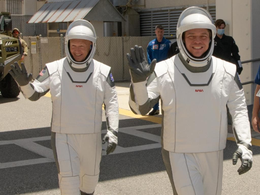 NASA astronauts Douglas Hurley, left, and Robert Behnken, wearing matchy-matchy SpaceX spacesuits, are seen as they depart the Neil A. Armstrong Operations and Checkout Building for Launch Complex 39A . Image credit: NASA/Bill Ingalls