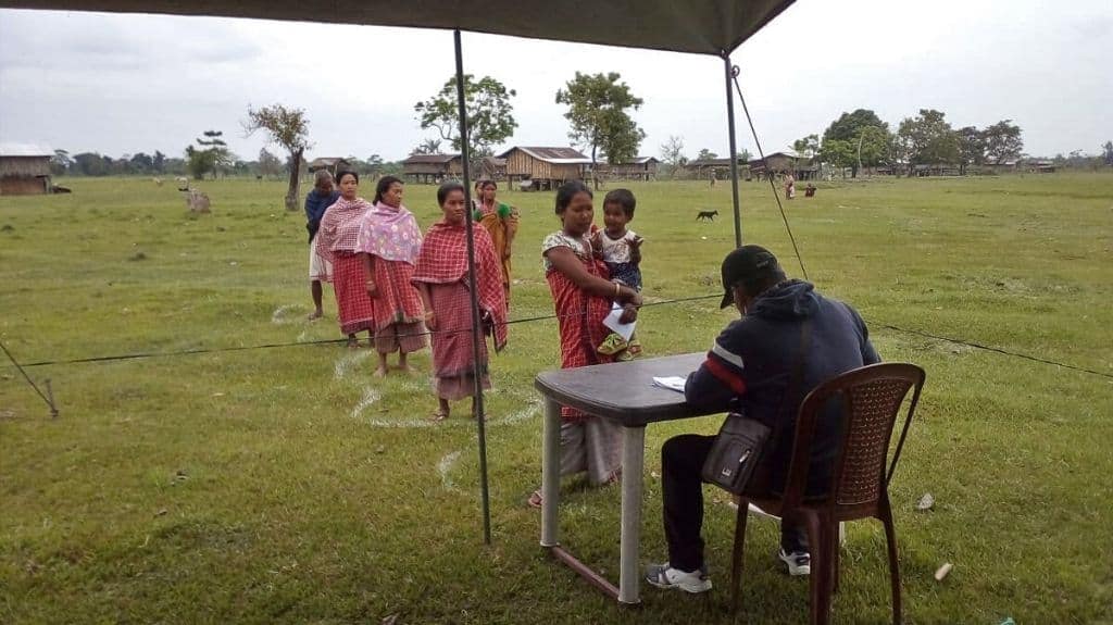 Riverine island dwellers maintaining social distancing during a routine check-up. Photo from Dibrugarh Boat Clinic.