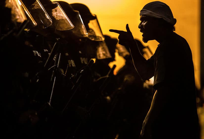 A protester vents at a line of Tucson Police Officers in riot gear at Cushing Street and Church Avenue early on Saturday. AP