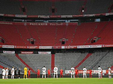 Players pay a minute of silence for the victims of the coronavirus prior to the Bundesliga match between Bayern Munich and Eintracht Frankfurt. AP