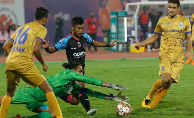 Amrinder Singh beats an onrushing attacker to the ball. Image credit: SportzPics
