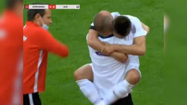 German second division player Dimitrij Nazarov breaks rules to celebrate goal with hug for driver that saved his life