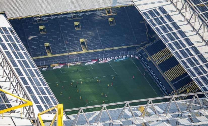 In this aerial image soccer players of both teams play the game in front of empty spectator stands during the German Bundesliga soccer match between Borussia Dortmund and FC Bayern Munich in Dortmund, Germany, Tuesday, May 26, 2020. The German Bundesliga is the world's first major soccer league to resume after a two-month suspension because of the coronavirus pandemic. (Marcel Kusch/DPA via AP, Pool)