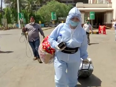 As railways resume train services, passengers eager to get home, arrive ahead of schedule; some don PPE suits to avoid infection As railways resume train services, passengers eager to get home, arrive ahead of schedule; some don PPE suits to avoid infection