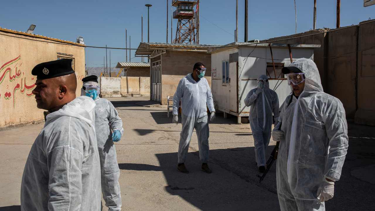 FILE – Iraqi border police at the Zurbatiya border crossing with Iran, Monday, March 9, 2020. The coronavirus has touched almost every country on earth, but its impact has seemed capricious as global metropolises like New York, Paris and London have been devastated, while teeming cities like Bangkok, Baghdad, New Delhi and Lagos have, so far, largely been spared. (Ivor Prickett/The New York Times)