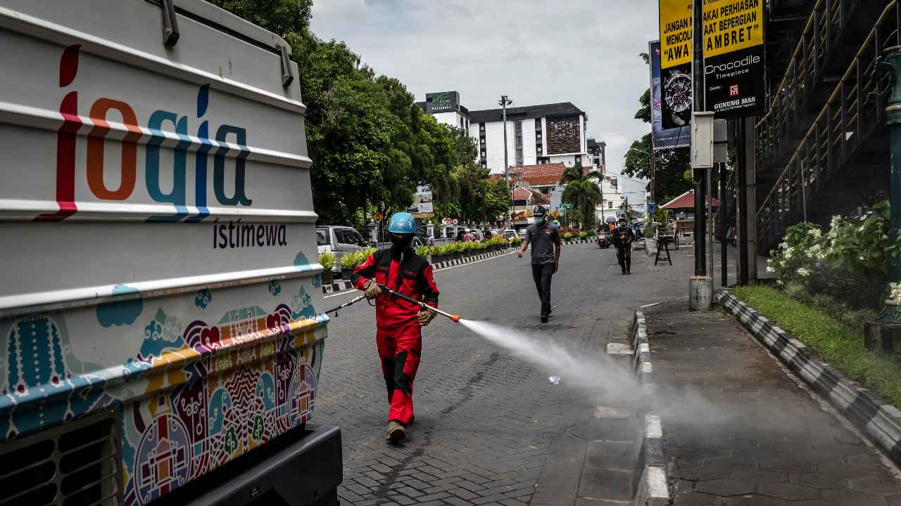 FILE – A worker disinfects a public area in Yogyakarta, Indonesia, March 18, 2020. The coronavirus has touched almost every country on earth, but its impact has seemed capricious as global metropolises like New York, Paris and London have been devastated, while teeming cities like Bangkok, Baghdad, New Delhi and Lagos have, so far, largely been spared. (Ulet Ifansasti/The New York Times)