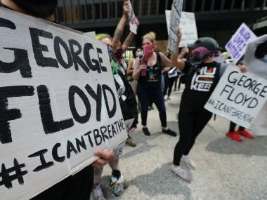 Protesters hold signs before they march during a protest over the death of George Floyd in Chicago, Saturday, May 30, 2020. Protesters protest in response to George Floyd's death in police custody in Minneapolis on Memorial Day. (AP Photo/Nam Y. Huh)