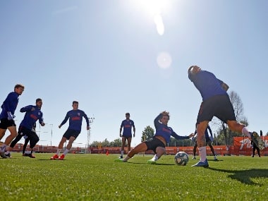 In this photo provided by Atletico Madrid, team players take part in the first group training session in Madrid, Spain, on Monday 18 May 2020. AP
