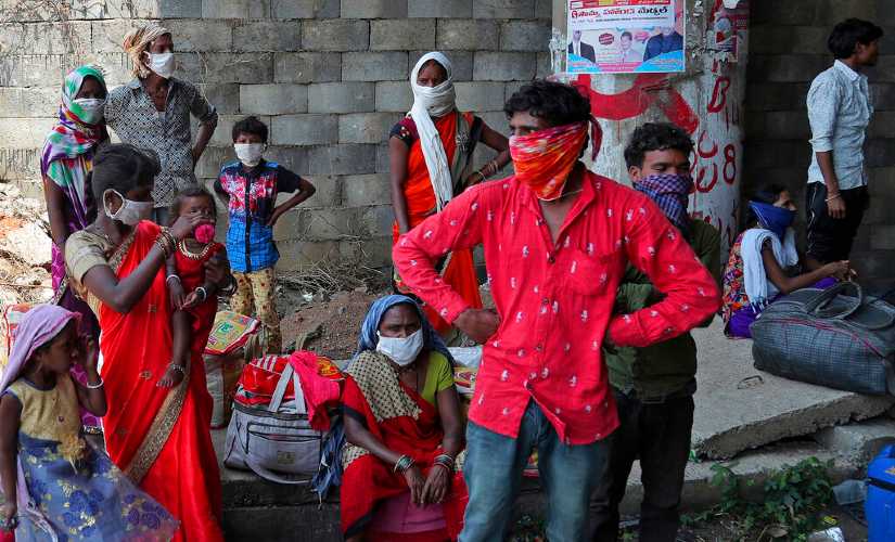 Migrant workers take a break as they walk during a nationwide lockdown from Hyderabad to their village in Maharashtra. AP