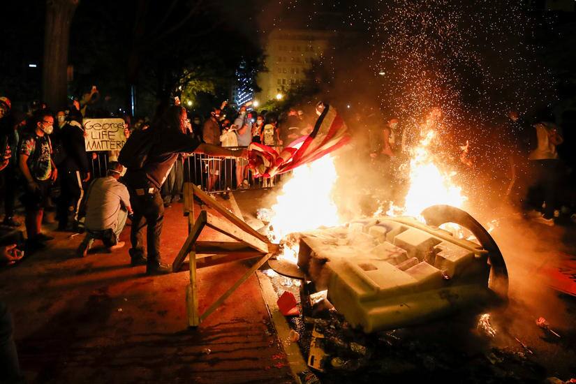 Demonstrators protesting the death of George Floyd start a fire near the White House in Washington AP.