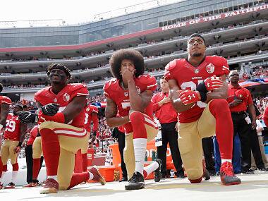 File image of San Francisco 49ers outside linebacker Eli Harold, quarterback Colin Kaepernick and safety Eric Reid kneel during the national anthem before an NFL football game. AP