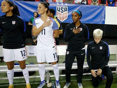 Fiel image of United States' Megan Rapinoe (R) kneels next to teammates as the national anthem is played before a match. AP