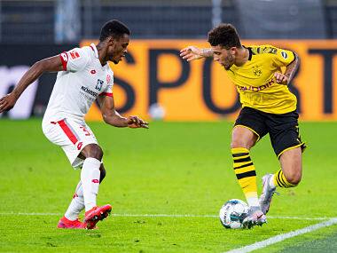 Mainz's Ridle Baku, and Dortmund's Jadon Sancho vie for the ball during their Bundesliga match. AP
