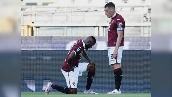 Serie A: Torino's Nicolas Nkoulou takes a knee after scoring against Parma as Italian league resumes