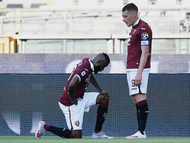 Serie A: Torino's Nicolas Nkoulou takes a knee after scoring against Parma as Italian league resumes