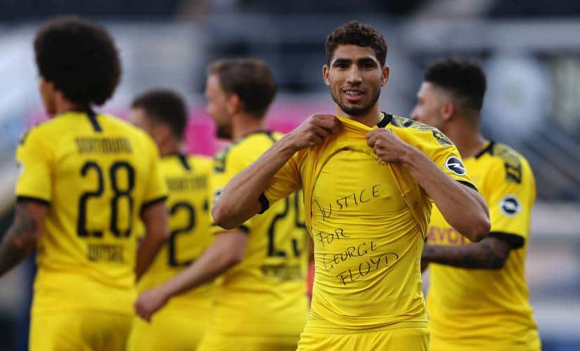 PADERBORN, GERMANY - MAY 31: Achraf Hakimi Mouh of Borussia Dortmund celebrates scoring his teams fourth goal of the game with a 'Justice for George Floyd' shirt during the Bundesliga match between SC Paderborn 07 and Borussia Dortmund at Benteler Arena on May 31, 2020 in Paderborn, Germany. (Photo by Lars Baron/Getty Images)