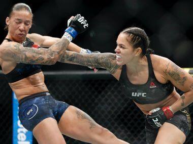 File-This Dec. 14, 2019, file photo shows Amanda Nunes, right, hitting Germaine de Randamie in a mixed martial arts women's bantamweight championship bout at UFC 245, in Las Vegas. Nunes, the pound-for-pound superstar is an overwhelming favorite in her featherweight title defense against Canadian contender Felicia Spencer in UFC 250 scheduled for Saturday, June 6, 2020. (AP Photo/John Locher, File)