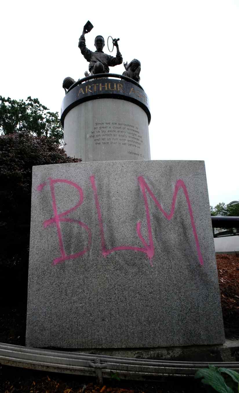 BLM (Black Lives Matter) was painted over WLM (White Lives Matter) graffiti after scrubbing, on the Arthur Ashe statue on Monument Ave. in Richmond, VA Wednesday mroning, June 17, 2020. (AP Photo/Richmond Times-Dispatch, Bob Brown).