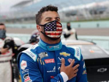 Bubba Wallace stands for the national anthem before a NASCAR Cup Series auto race Sunday, June 14, 2020, in Homestead, Fla. (AP Photo/Wilfredo Lee)