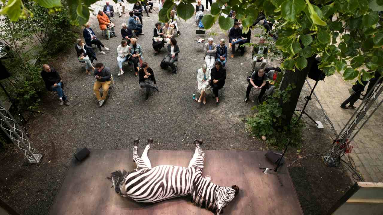 An audience waits for the beginning of a performance of Berthold Brecht’s ‘Baal’ during a public rehearsal of the Berliner Ensemble theater in Berlin, on 9 June 2020. The theater will start again on 11 July 2020, with public performances after the lockdown because of the coronavirus outbreak, but under safety restrictions and in the courtyard of the building. Image: AP Photo/Markus Schreiber