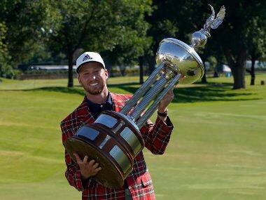 Daniel Berger poses with the championship trophy after winning the Charles Schwab Challenge golf tournament. AP