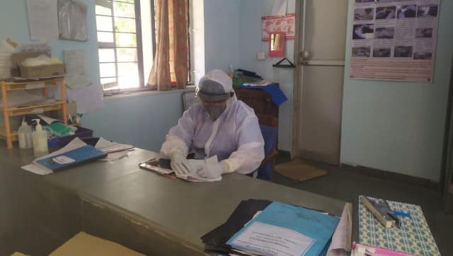 Working through patient records dressed in a PPE suit. Image courtesy: Dr Nahush Chafekar