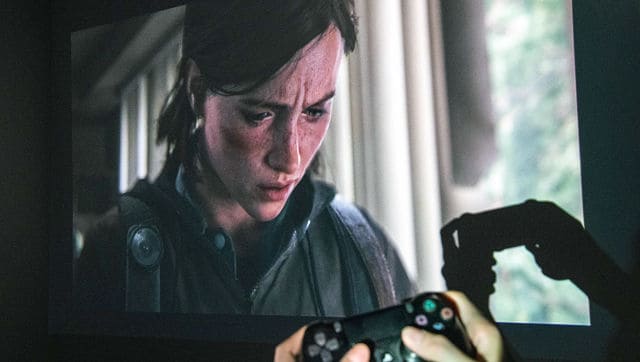 The character Ellie is visible on a monitor as a gamer plays The Last of Us Part II. By Brian Finke © 2020 The New York Times