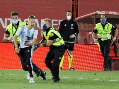 A supporter invades the pitch during the Spanish La Liga football match between Mallorca and FC Barcelona. AP