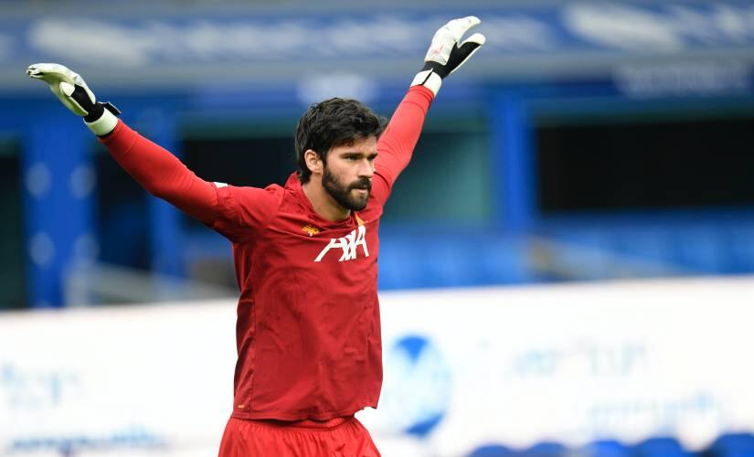 Liverpool's goalkeeper Alisson warms-up before the English Premier League soccer match between Everton and Liverpool at Goodison Park in Liverpool, England, Sunday, June 21, 2020. (Peter Powell/Pool via AP)